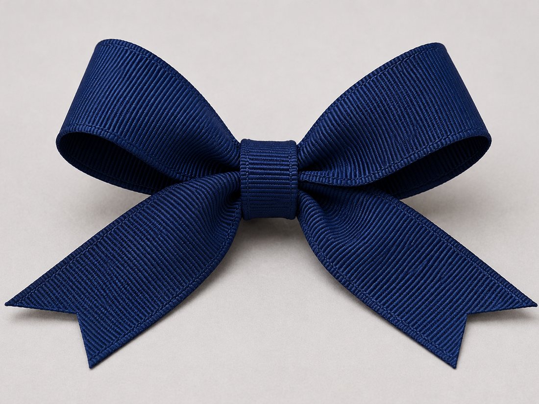 A navy grosgrain ribbon tied in a firm bow